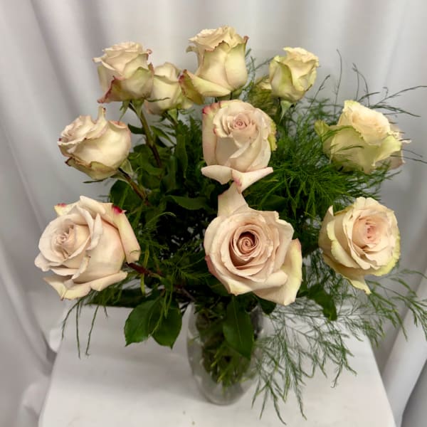 Bouquet of pale blush roses in a clear glass vase