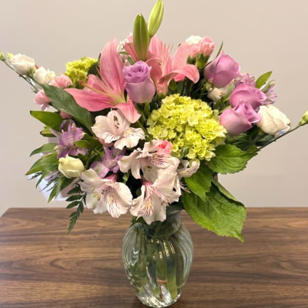Pink and lavender mixed bouquet in a clear glass vase