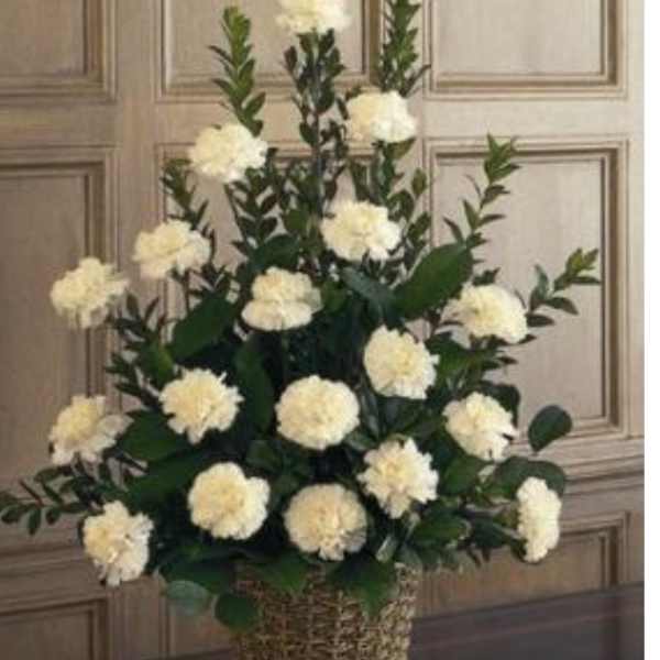 White pompom flowers arranged in a wicker basket