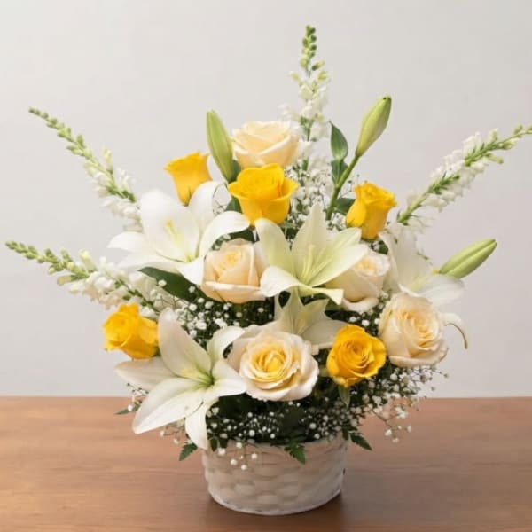 White lilies and yellow roses arranged in a woven basket