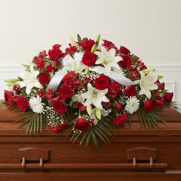 Red and white floral casket spray with roses and lilies