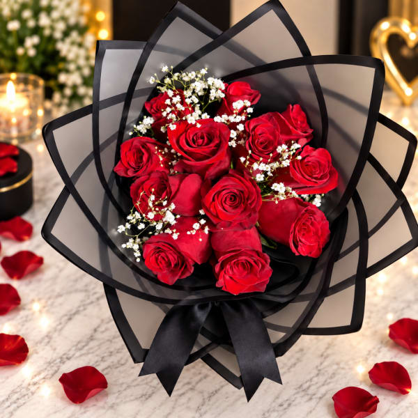 Bouquet of red roses with white baby's breath in black wrap