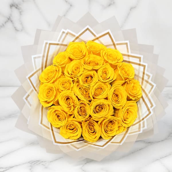 Bouquet of yellow roses wrapped in translucent paper