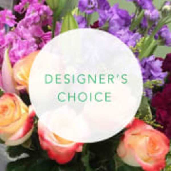 Mixed bouquet with pink and purple flowers and a designer's choice label