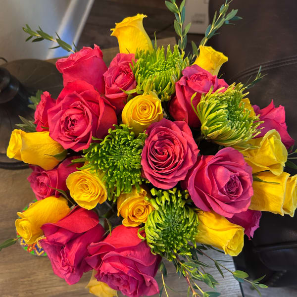 Bouquet of pink and yellow roses with green chrysanthemum blooms