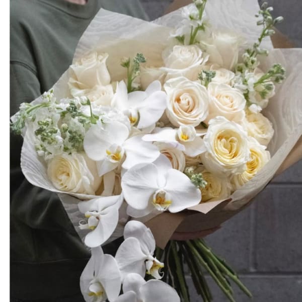 White roses and orchids wrapped in paper