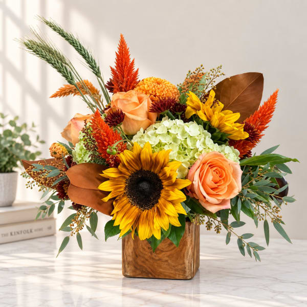 Sunflower and rose arrangement in a wooden cube vase