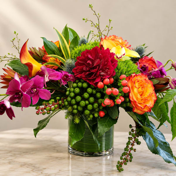 Colorful mixed flower arrangement in a clear glass vase