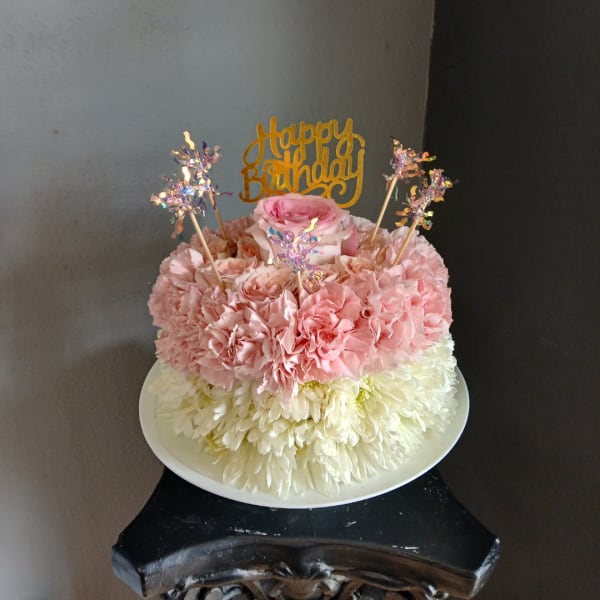 Pink and white flower cake with a Happy Birthday topper