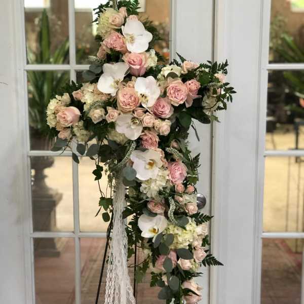 Tall floral standing arrangement with pink roses and white orchids