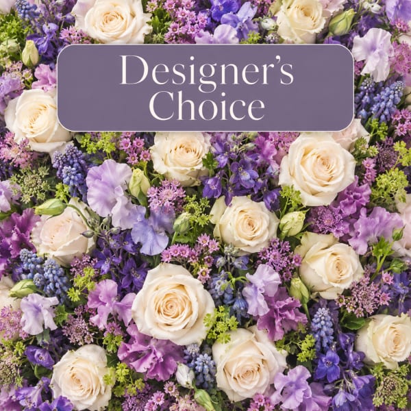 Mixed bouquet of cream roses and purple flowers with a designer's choice sign
