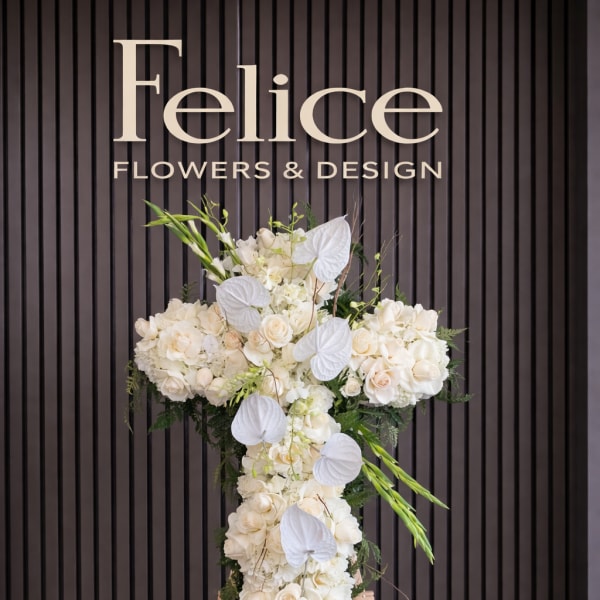 White floral standing cross on an easel