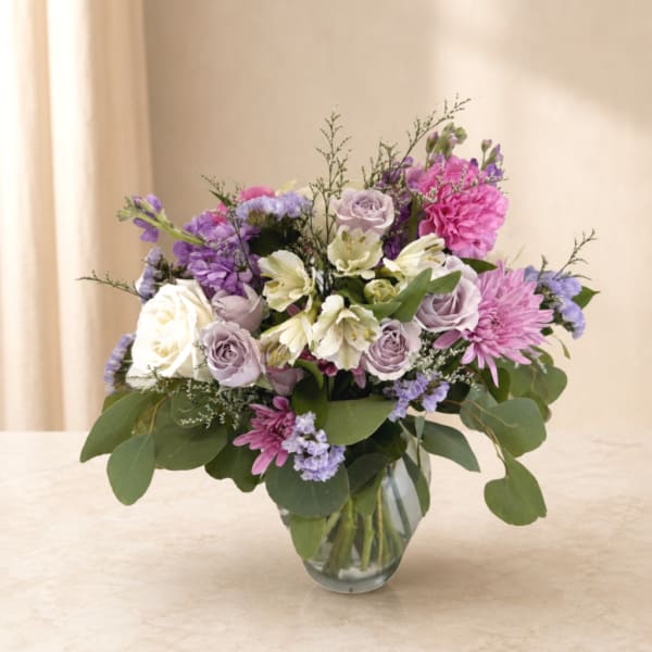 Lavender and pink mixed bouquet in a clear glass vase
