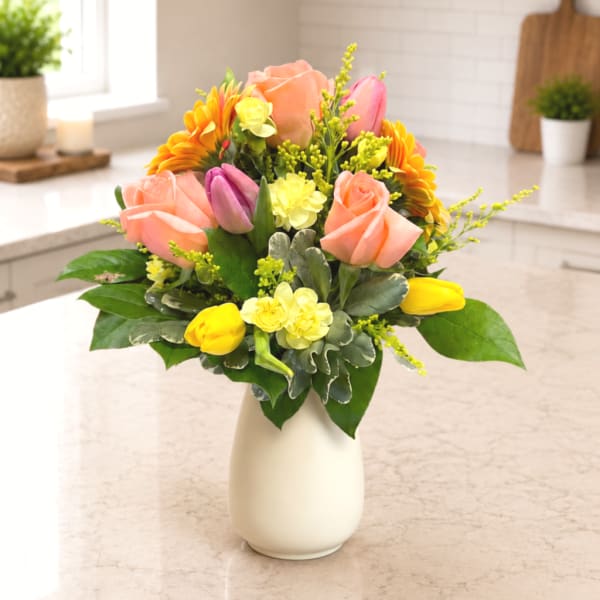 Mixed bouquet of roses and tulips in a white vase