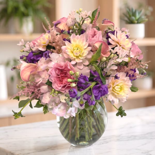 Mixed pink and purple bouquet in a clear glass vase