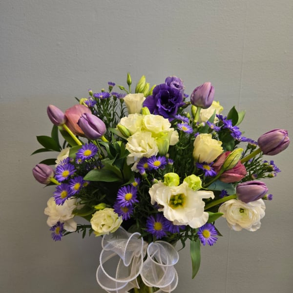 Bouquet of purple tulips, white lisianthus, and small purple daisies