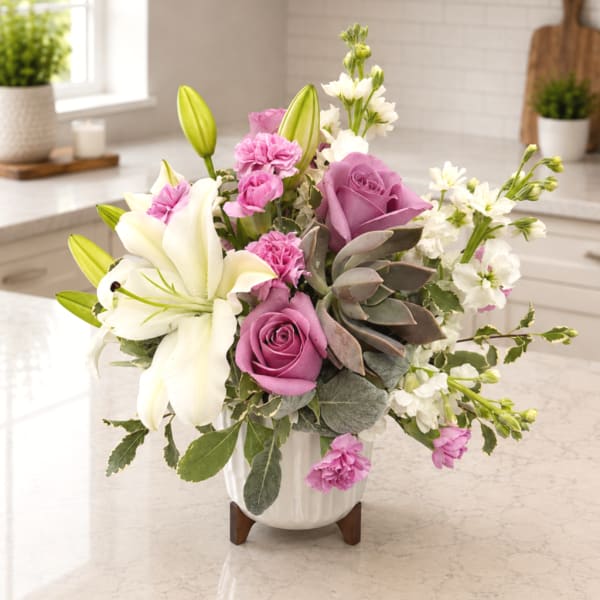 Pink and white floral arrangement in a white vase