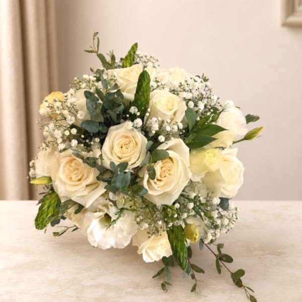 Cream rose bridal bouquet with baby's breath and greenery