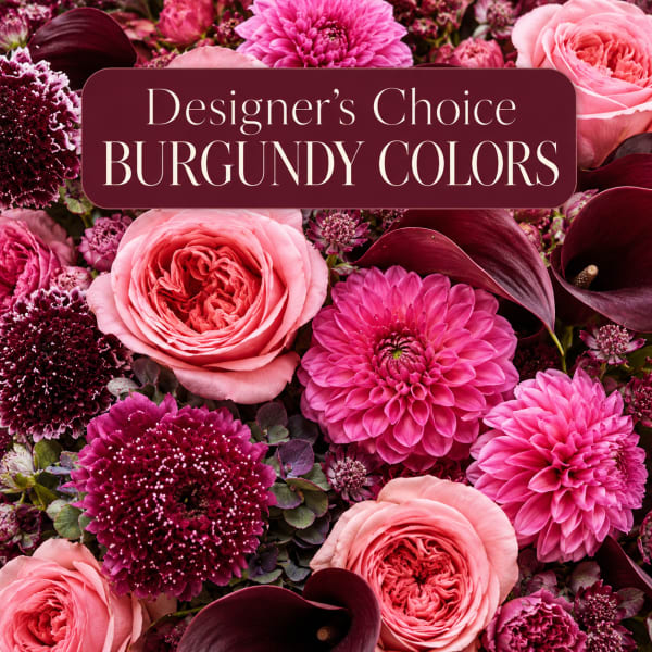 Burgundy and pink floral arrangement with roses, dahlias, and calla lilies