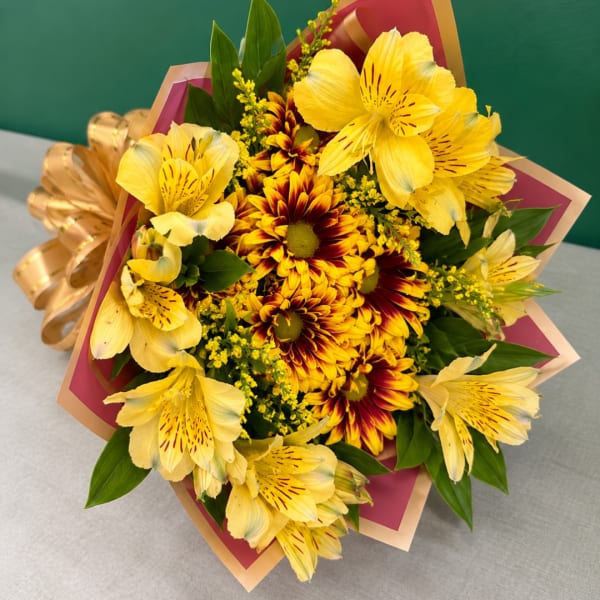 Yellow alstroemeria and red-yellow chrysanthemums in a wrapped bouquet