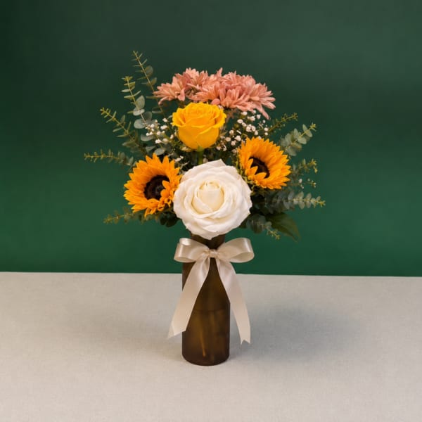 Bouquet of roses and sunflowers in a brown vase with a ribbon