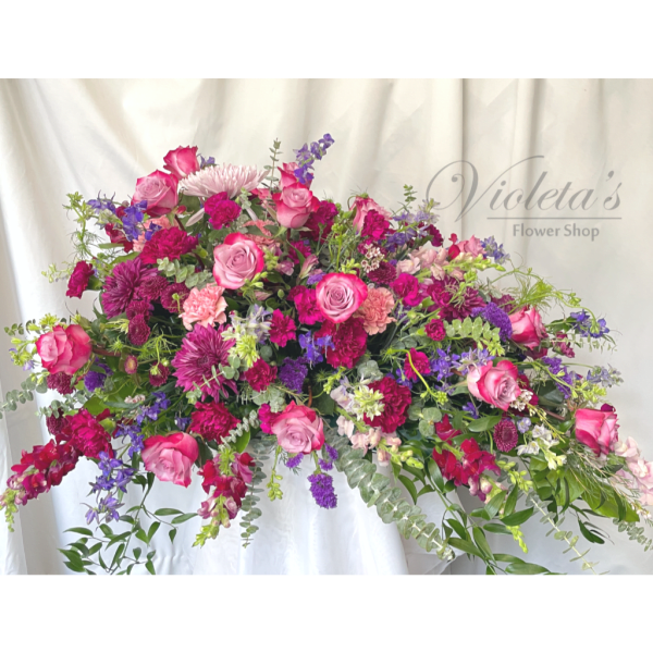 Large pink and purple mixed flower arrangement with roses and carnations