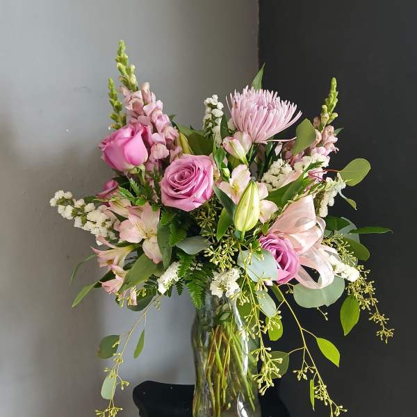 Pink mixed flower bouquet in a clear glass vase