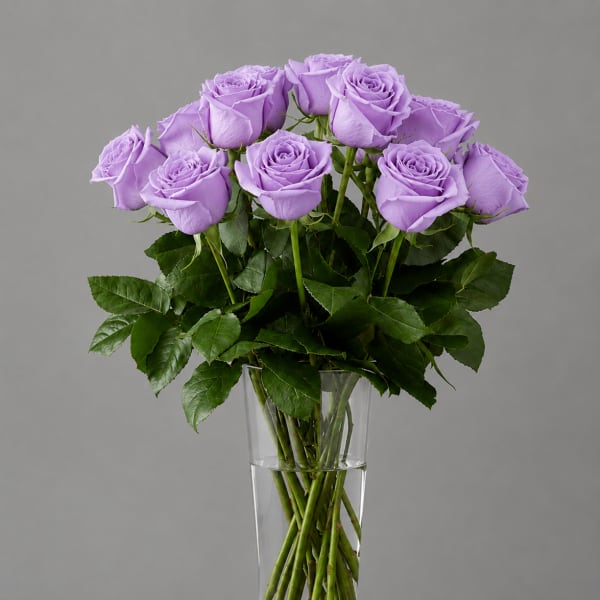 Lavender roses arranged in a clear glass vase