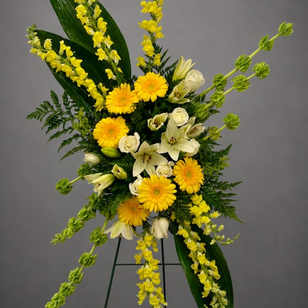 Yellow and white floral standing spray on an easel