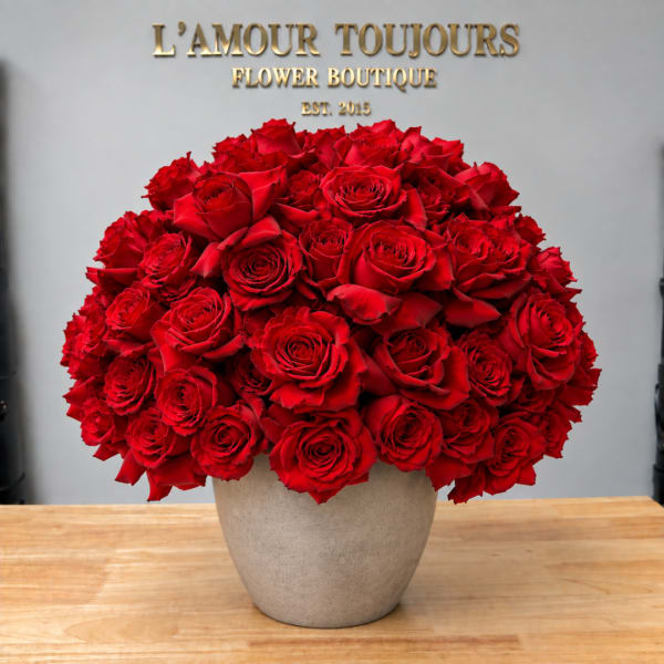 Large bouquet of red roses in a beige vase
