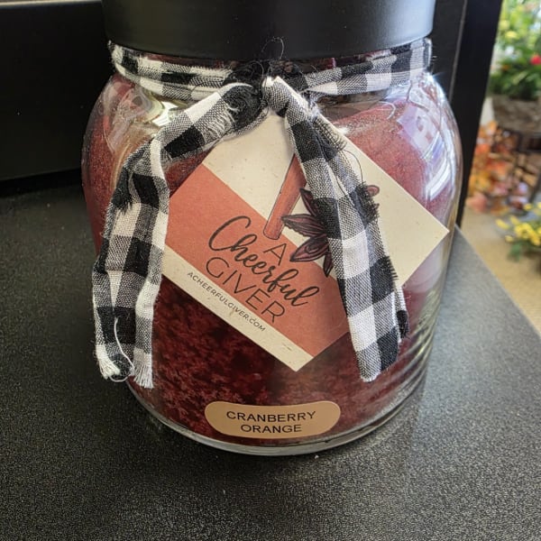 Jar candle with a black-and-white ribbon and cranberry orange label