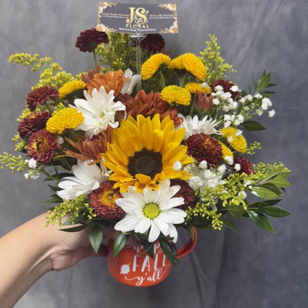 Mixed bouquet with a sunflower in a red mug