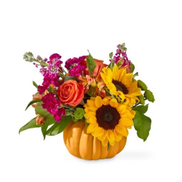 Sunflowers and roses arranged in a pumpkin-shaped container