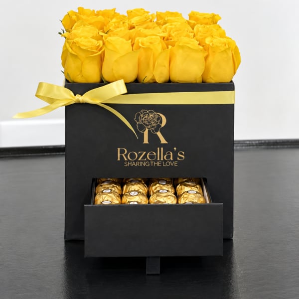 Yellow roses in a black gift box with a drawer of chocolates