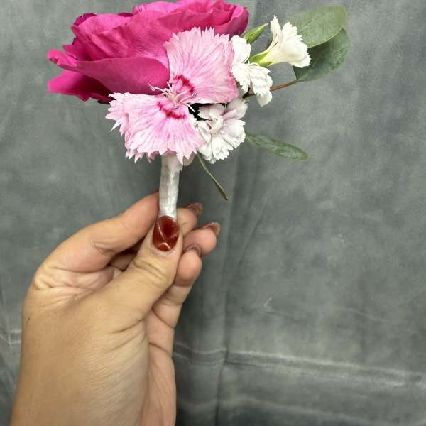 Hot pink spray roses with white boutonnière
