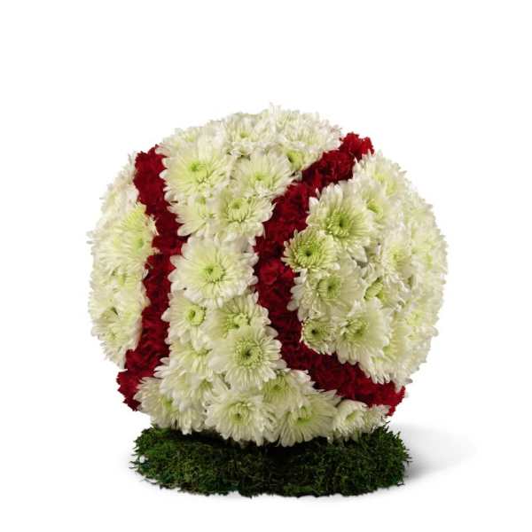 Round floral arrangement of white and red chrysanthemums on a moss base
