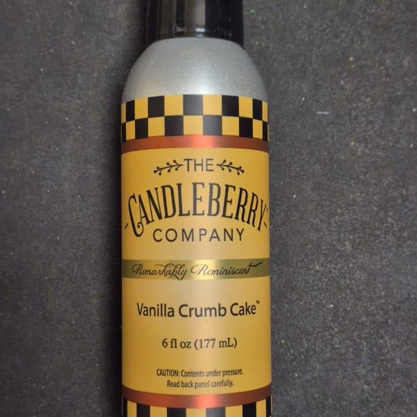 A vanilla crumb cake scented candle spray bottle with a yellow label