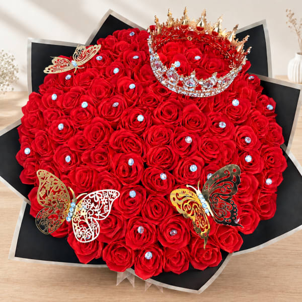 Large bouquet of red roses with butterfly decorations and a jeweled crown