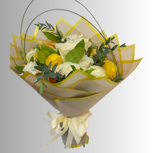 Bouquet of white and yellow roses wrapped in beige paper with a ribbon