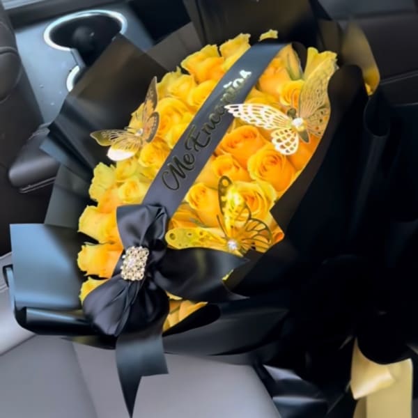Yellow rose bouquet wrapped in black paper with butterfly decorations