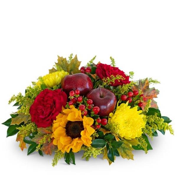 Autumn floral arrangement with red roses, yellow flowers, and decorative apples