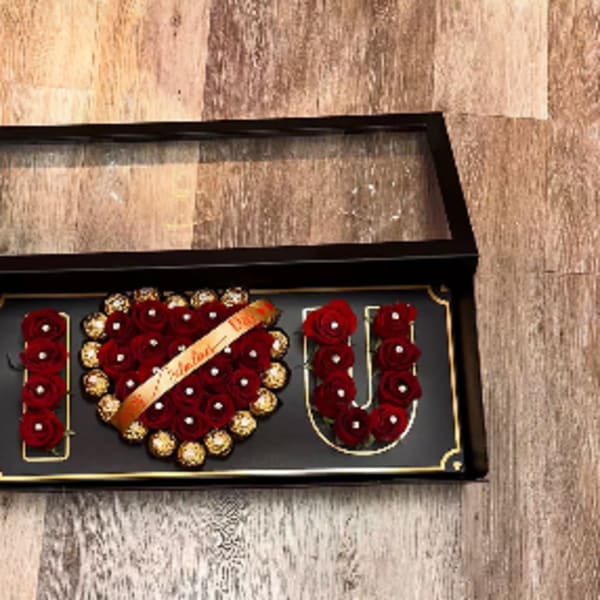 Boxed rose arrangement spelling I love you with chocolates