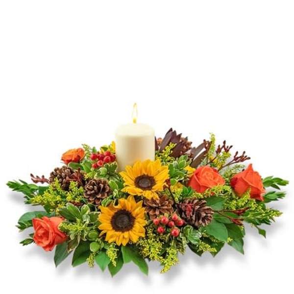 Candle centerpiece with sunflowers and orange roses