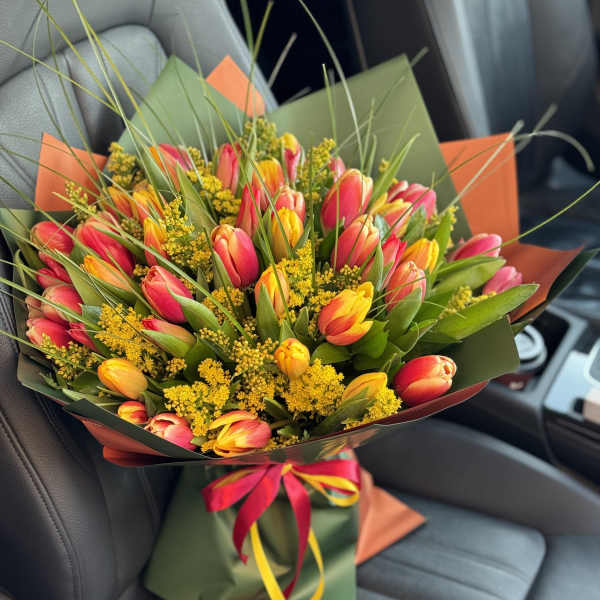 Bouquet of pink and yellow tulips with yellow filler flowers