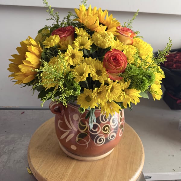 Yellow mixed bouquet with roses in a patterned ceramic vase