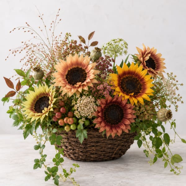 Basket arrangement with sunflowers and mixed autumn flowers