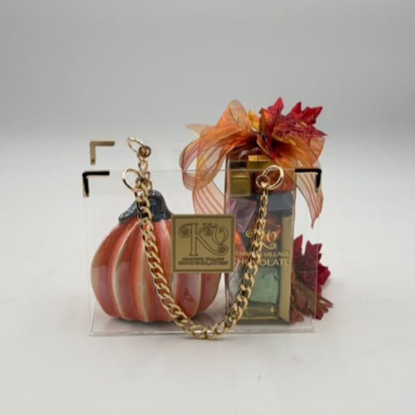 Gift bag with a pumpkin decoration and boxed chocolates