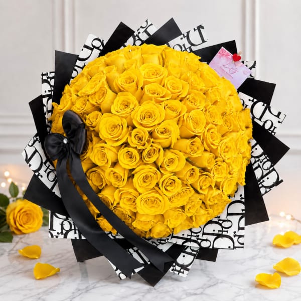 Large bouquet of yellow roses wrapped in black and white paper with a black ribbon
