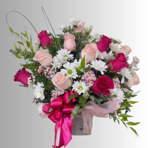 Bouquet of pink roses and white daisies with a pink ribbon