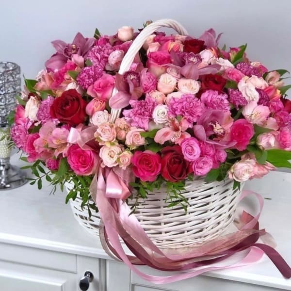 Pink and red mixed flower basket with ribbon handles